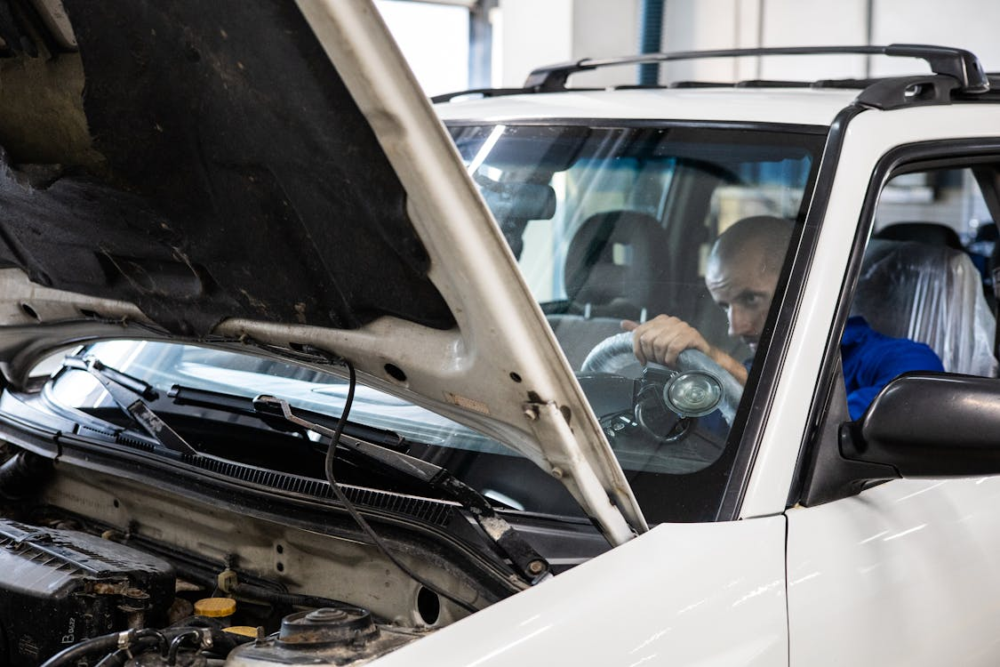 Car Mechanic Repairing Engine