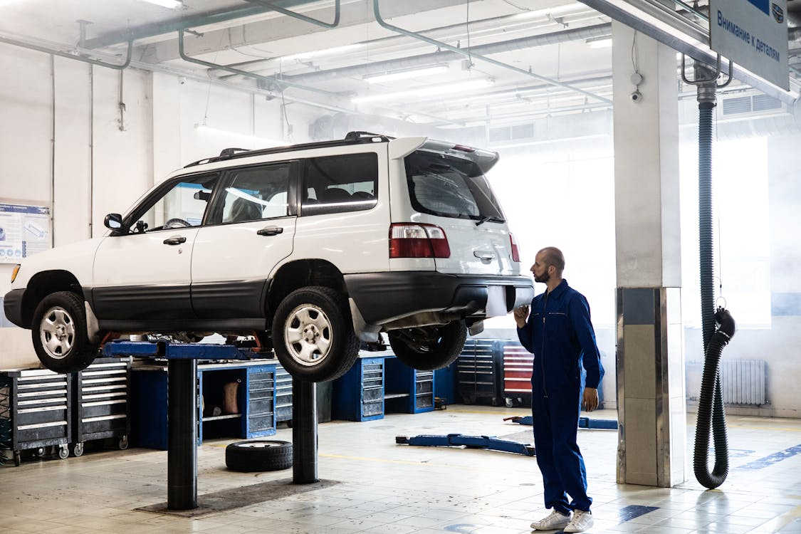 Car Mechanic Repairing Engine