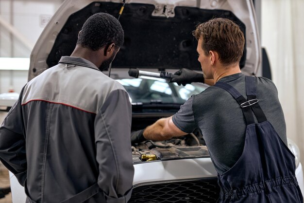 team of mechanics working on a car
